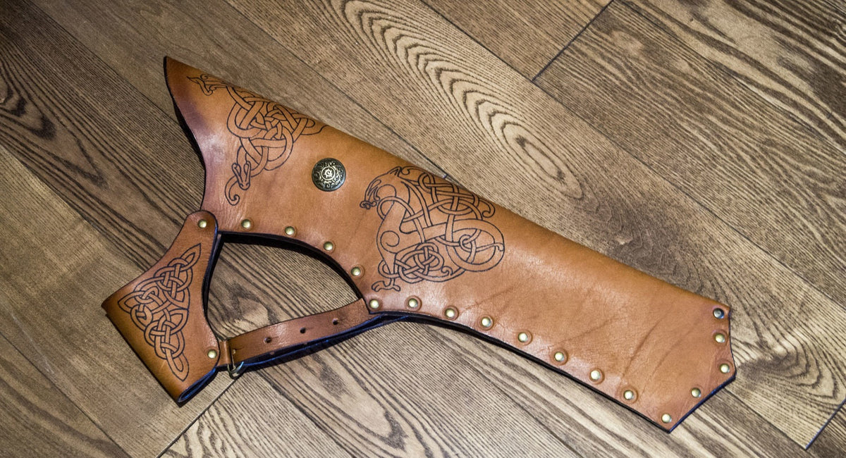 Light brown leather hip quiver laid flat with articulated belt hanger