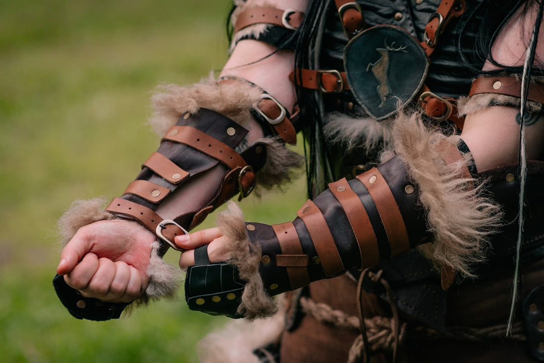 Brown and black leather bracers with fur trim being fastened outdoors
