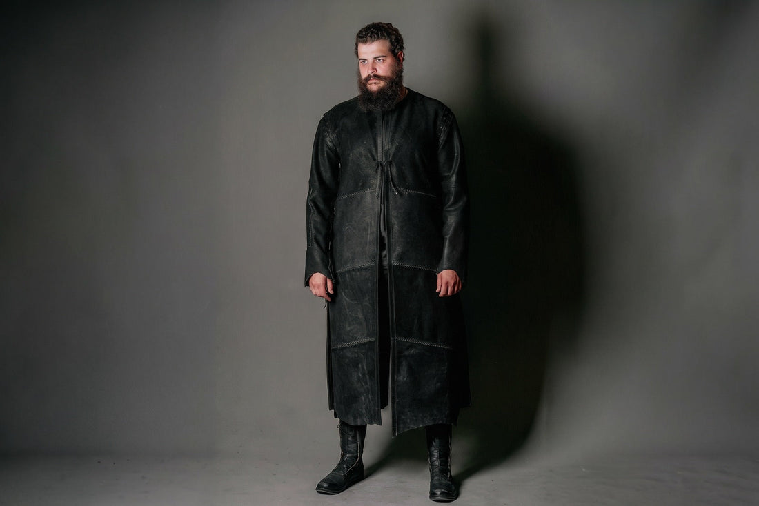 Model wearing a long black leather Aragorn Strider duster with front ties and stitched panels