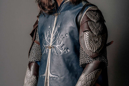 Three-quarter view of the blue leather Aragorn King costume layer with brown shoulder armor and bracers