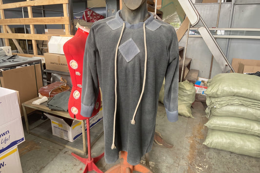 Gray-blue Warlord medieval tunic displayed on a dress form in the SokolArmory workshop