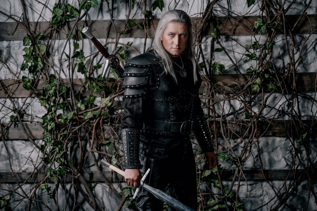 Three-quarter view of the Geralt Season 2 costume showing layered shoulder armor, cuirass side fit, bracer, belt, and pants