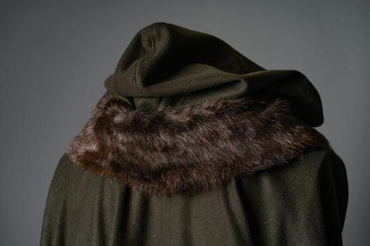 Close view of a dark green Witcher wool cloak with a broad brown fur-trimmed hood