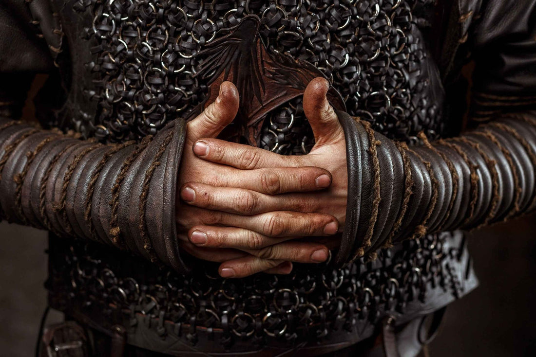 Close view of paired dark leather Ragnar bracers worn over sleeves and chainmail