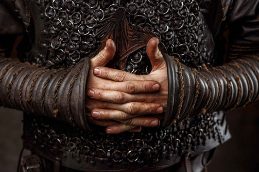 Close view of paired dark leather Ragnar bracers worn over sleeves and chainmail
