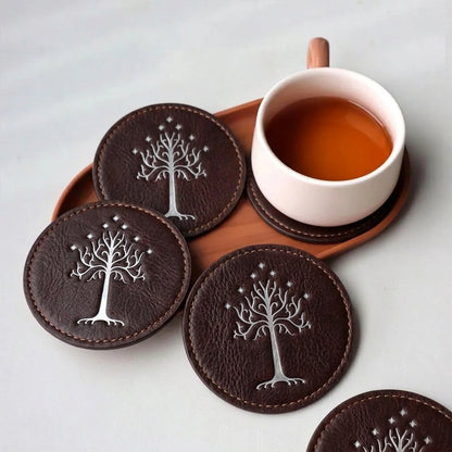 Fantasy brown leather coaster set with White Tree motif beside a cup of tea
