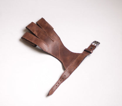 Open adjustable wrist strap and buckle on the leather archery glove