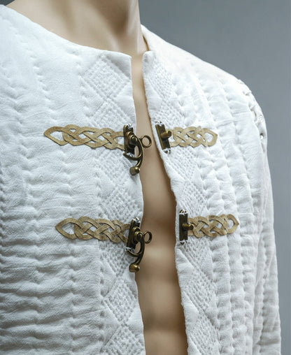 Close-up of leather ornament and metal closures on quilted jacket