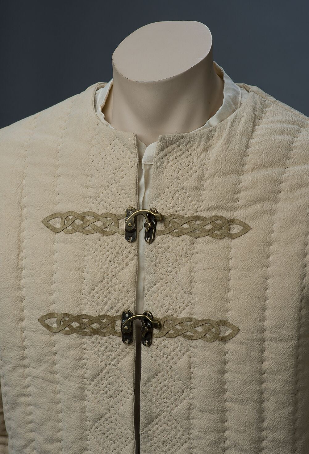 Close-up of textured quilting and front closures