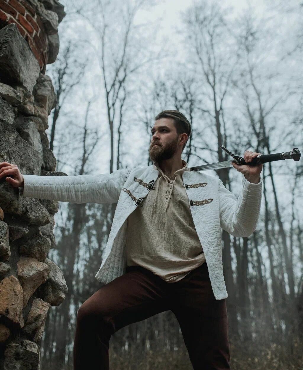 King Arthur inspired quilted jacket worn in a fantasy action scene