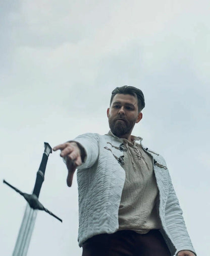Low-angle view of ivory quilted jacket worn with medieval clothing