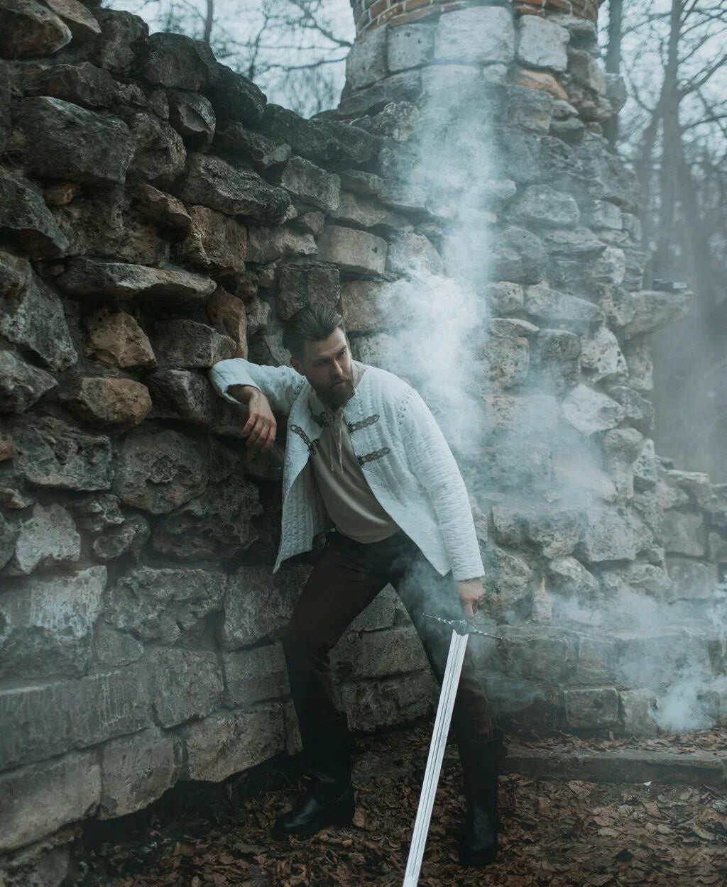 Quilted cotton medieval jacket worn with a sword at castle ruins