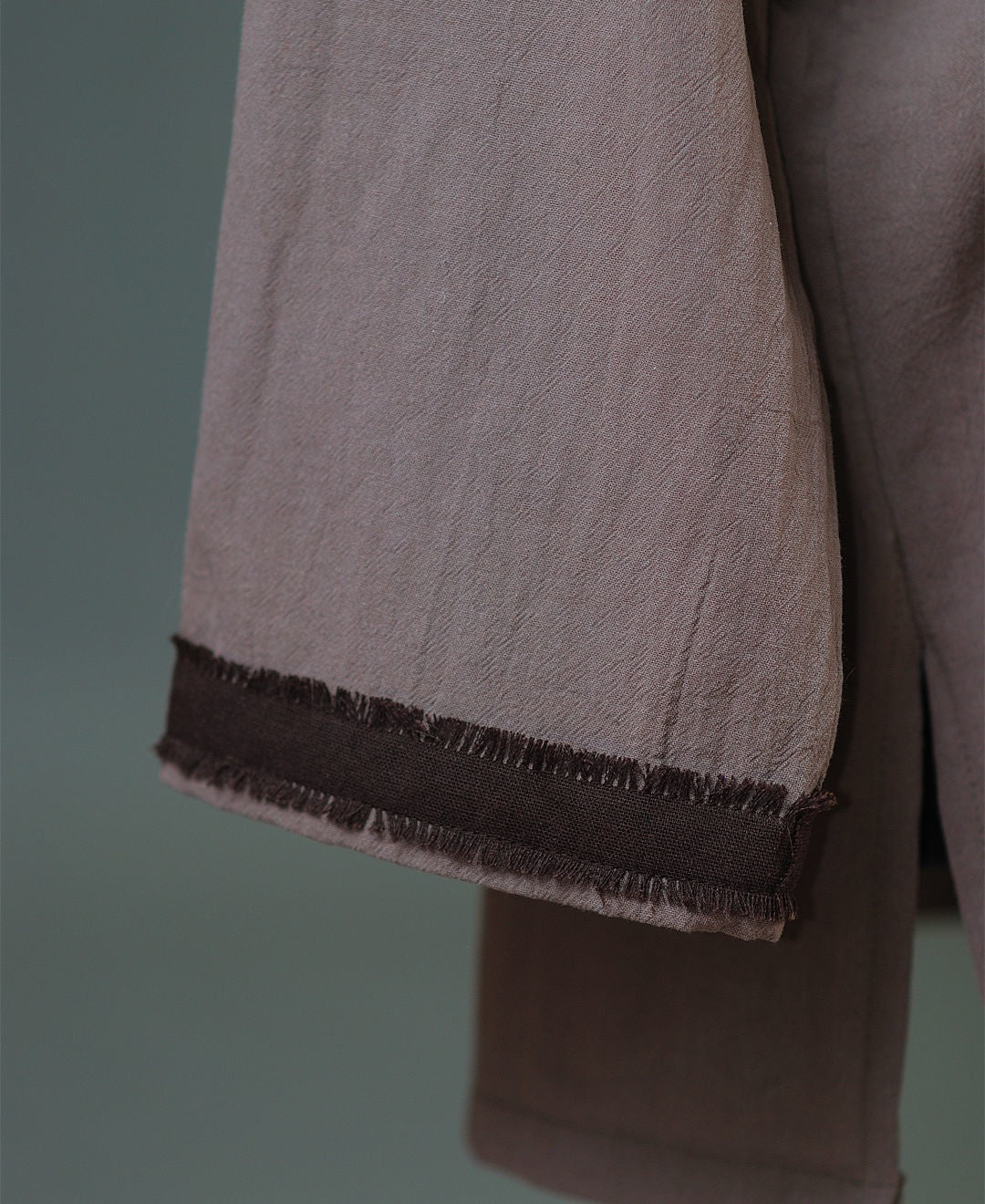 Close view of cotton shirt neckline and linen belt