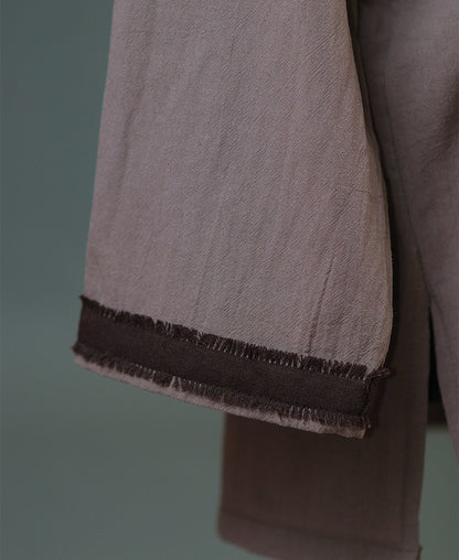 Close view of cotton shirt neckline and linen belt