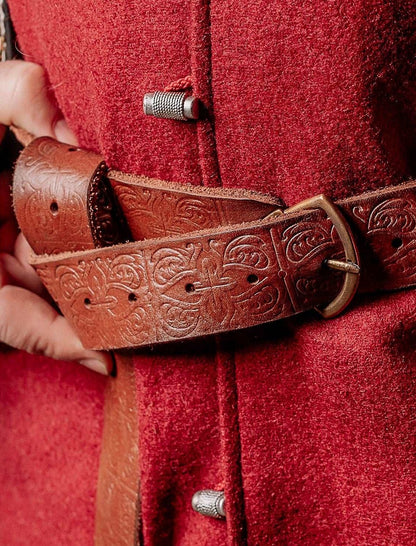 a pair of red scissors on a red cloth 