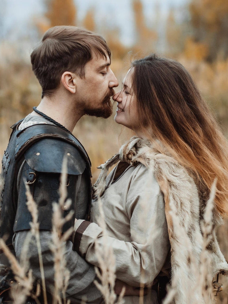 a man and woman are talking on a cell phone 