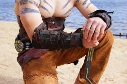 a man holding a catchers mitt on a beach 