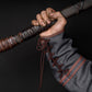 a man holding a baseball bat in a dark room 