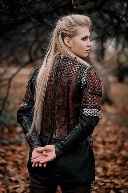 a woman standing in front of a tree 